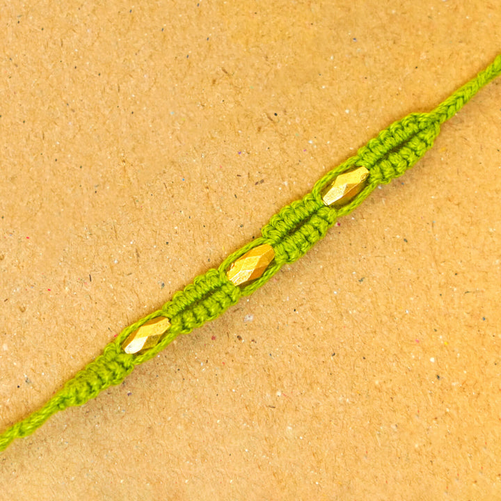 Handmade Macrame Three Gold Beaded Rakhi With Roli Chawal - Close-up Detail (7)