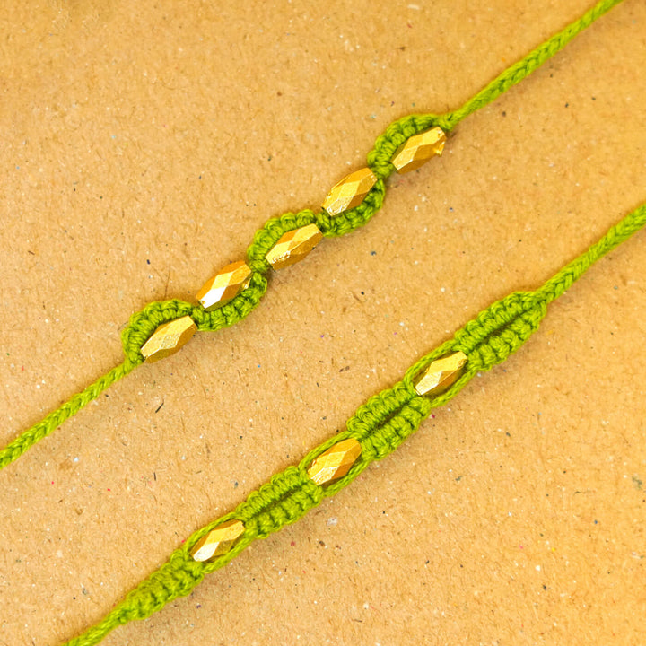 Handmade Macrame Beaded Rakhi With Roli Chawal Set Of 2 - Close-up of green pair