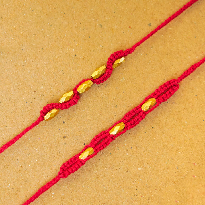 Handmade Macrame Beaded Rakhi With Roli Chawal Set Of 2 - Close-up of red pair
