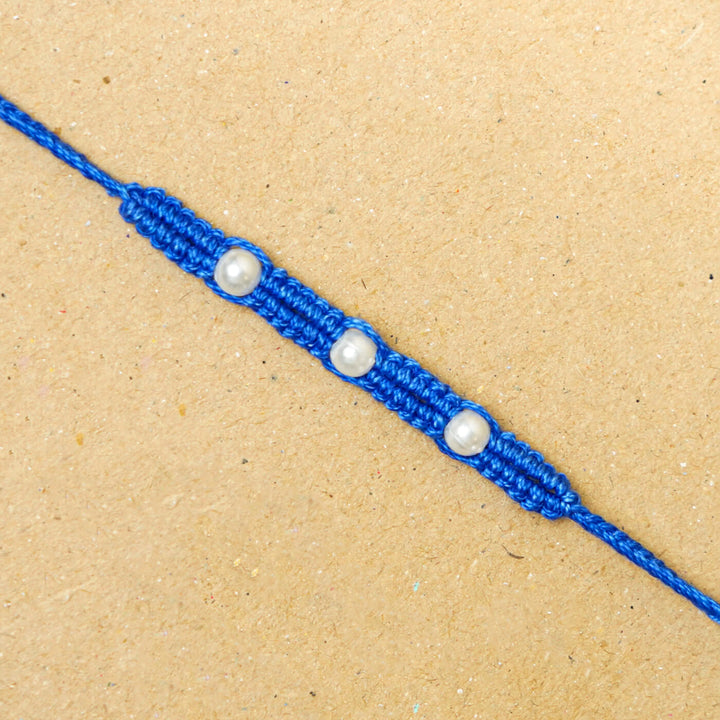 Handmade Macrame Three Pearl Rakhi With Roli Chawal - Close-up Front View (2)