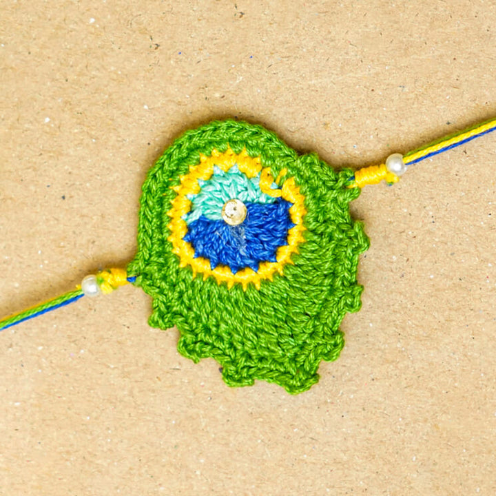 Handmade Crochet Peacock Feather Cotton Rakhi With Roli Chawal - Close-up of Crocheted Rakhi