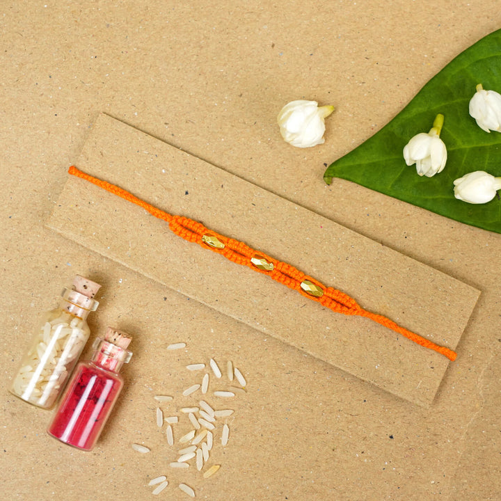 Handmade Macrame Three Gold Beaded Rakhi With Roli Chawal - Displayed on Card with Props (11)