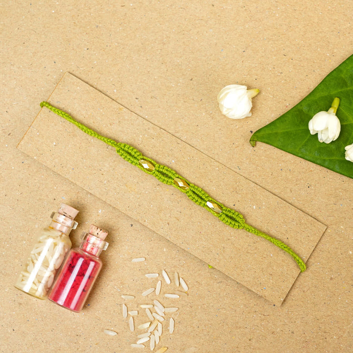 Handmade Macrame Three Gold Beaded Rakhi With Roli Chawal - Displayed on Card with Props (8)