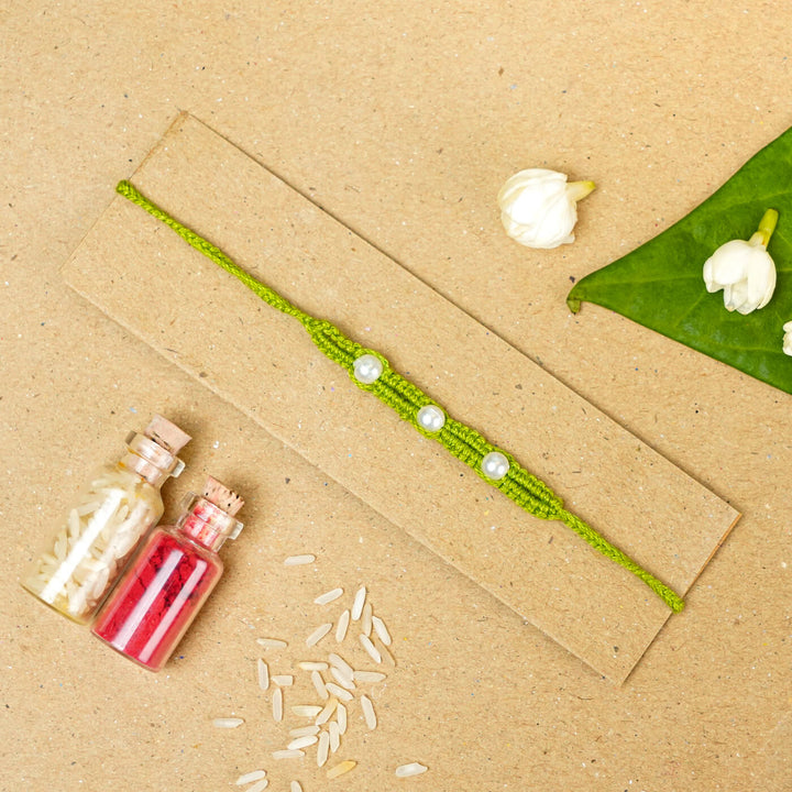 Handmade Macrame Three Pearl Rakhi With Roli Chawal - Flat Lay with Decorative Items (6)
