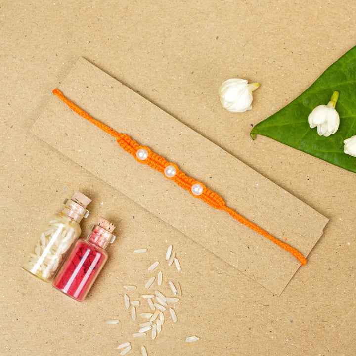 Handmade Macrame Three Pearl Rakhi With Roli Chawal - Flat Lay with Decorative Items (11)