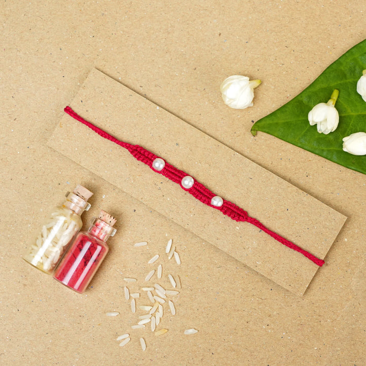 Handmade Macrame Three Pearl Rakhi With Roli Chawal - Flat Lay with Decorative Items (22)