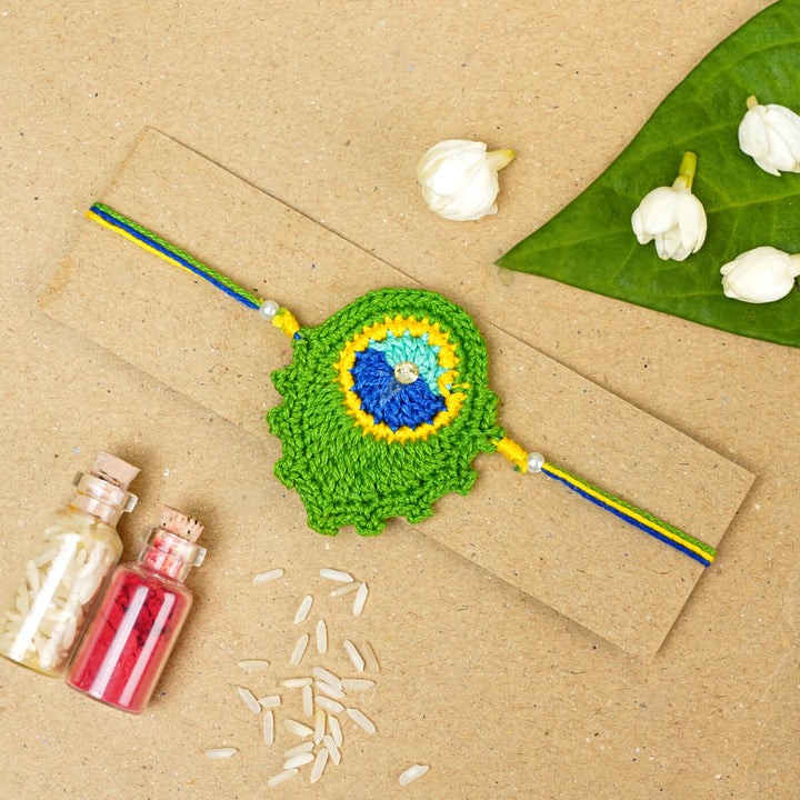 Handmade Crochet Peacock Feather Cotton Rakhi With Roli Chawal - Rakhi on Presentation Card with Decor