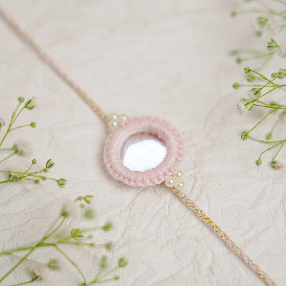 Handmade Darpan Mirror And Pearl Rakhi With Roli Chawal - Close-up with Decorative Flowers