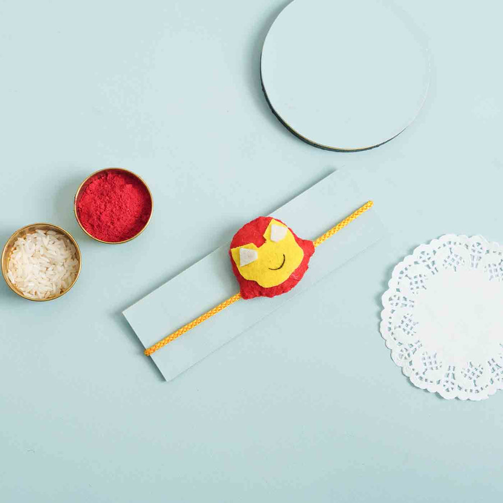 Handmade Ironman Felt Kids Rakhi With Roli Chawal - Styled product flat lay