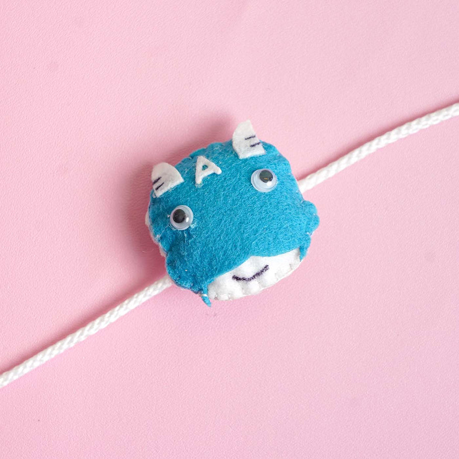 Handmade Captain America Felt Kids Rakhi With Roli Chawal - Close-up of Blue Felt Decoration