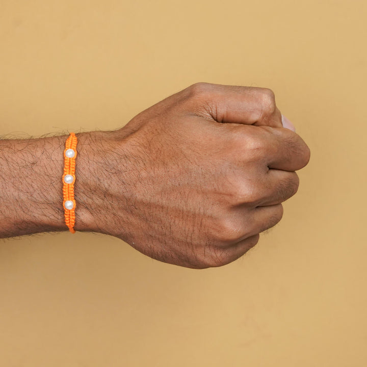 Handmade Macrame Three Pearl Rakhi With Roli Chawal - On Wrist View (10)