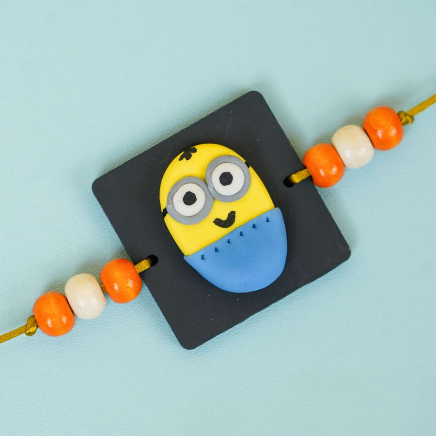 Handmade Miniature Clay Minion Kids Rakhi With Roli Chawal - Close-up of Minion Rakhi