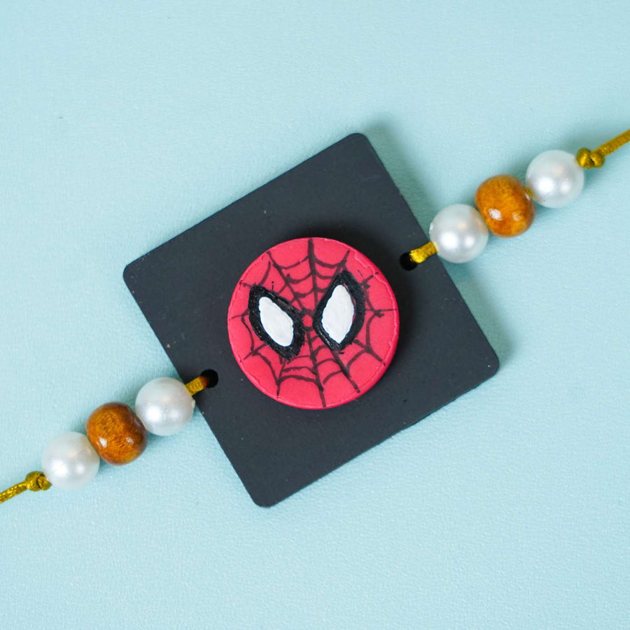 Handmade Miniature Clay Spiderman Kids Rakhi With Roli Chawal - Close-up of Spiderman Rakhi face