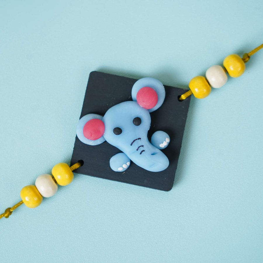Handmade Miniature Clay Elephant Themed Kids Rakhi With Roli Chawal - Close-up of Elephant Charm