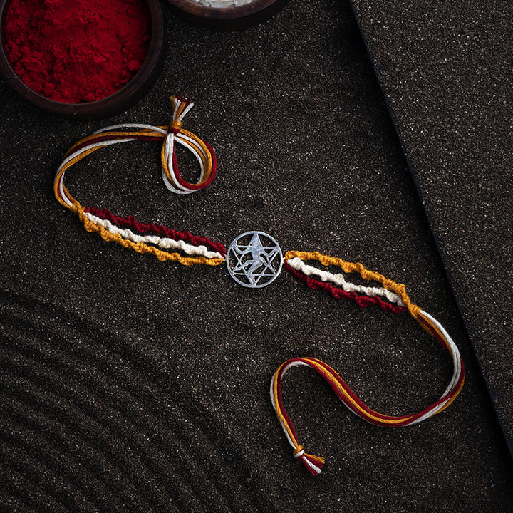 Handmade Bhairav 925 Silver Rakhi With Roli Chawal For Brother - Full View on Textured Surface