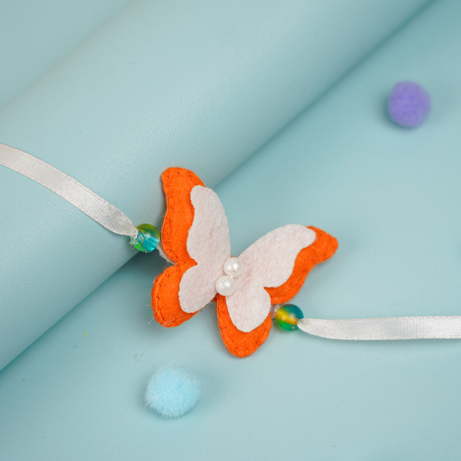 Customized Handmade Beaded Butterfly Theme Pom Pom Felt Rakhi With Roli Chawal For Kids - Close-up on Butterfly Detail
