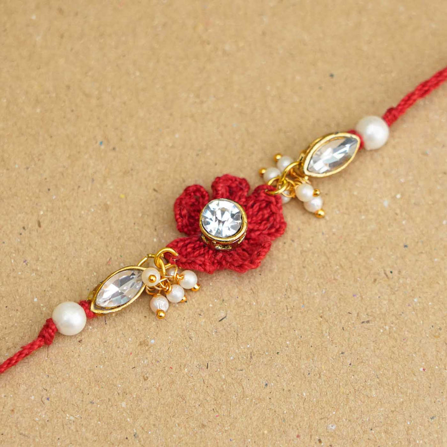 Handmade Kundan Floral Red Rakhi With Roli Chawal - Close-up of decorative centerpiece