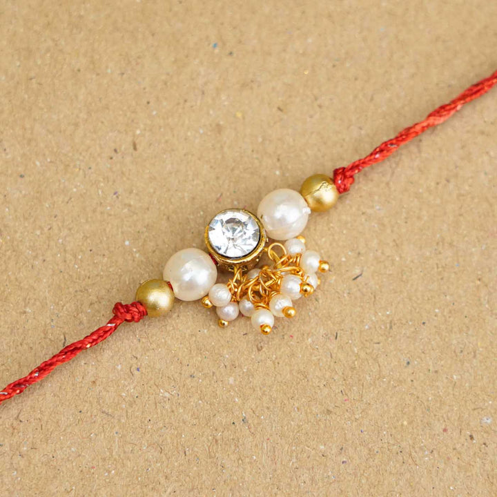 Handmade Kundan Red And White Beads Rakhi With Roli Chawal - Close-up of central decorative detail