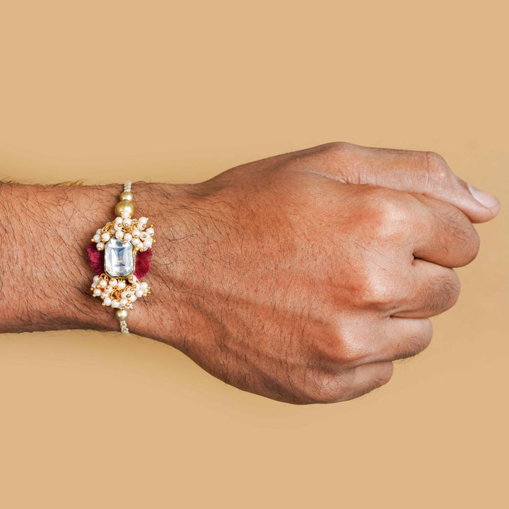 Handmade Large Kundan Stone Pearl Rakhi With Roli Chawal - Rakhi worn on wrist close-up