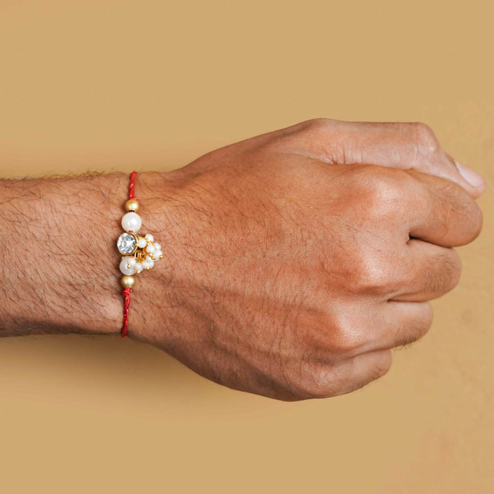 Handmade Kundan Red And White Beads Rakhi With Roli Chawal - Model wearing bracelet on wrist
