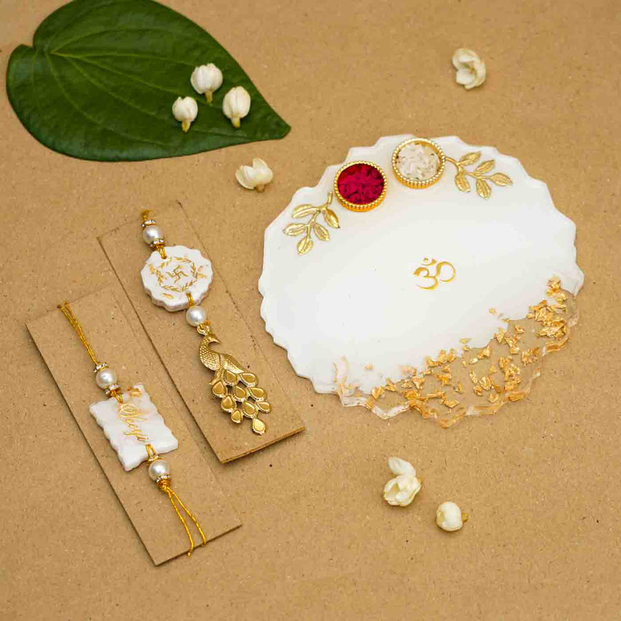 Personalized Handmade White Resin Rakhi Thali With Roli Chawal For Bhaiya And Bhabhi Set Of 3 - Overhead view of jewelry and tray