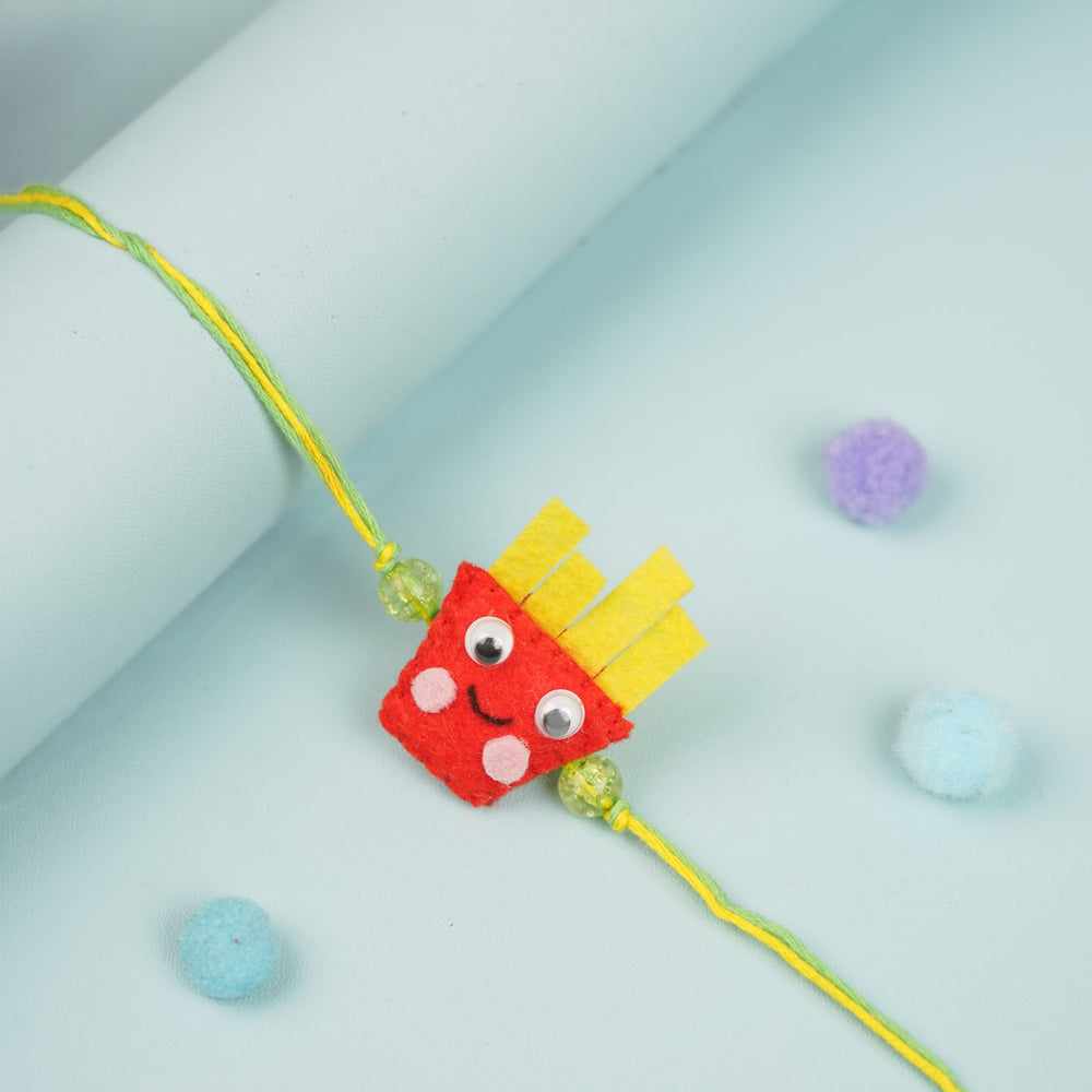 Handmade French Fries Theme Felt Kids Rakhi - Rakhi laid on rolled background