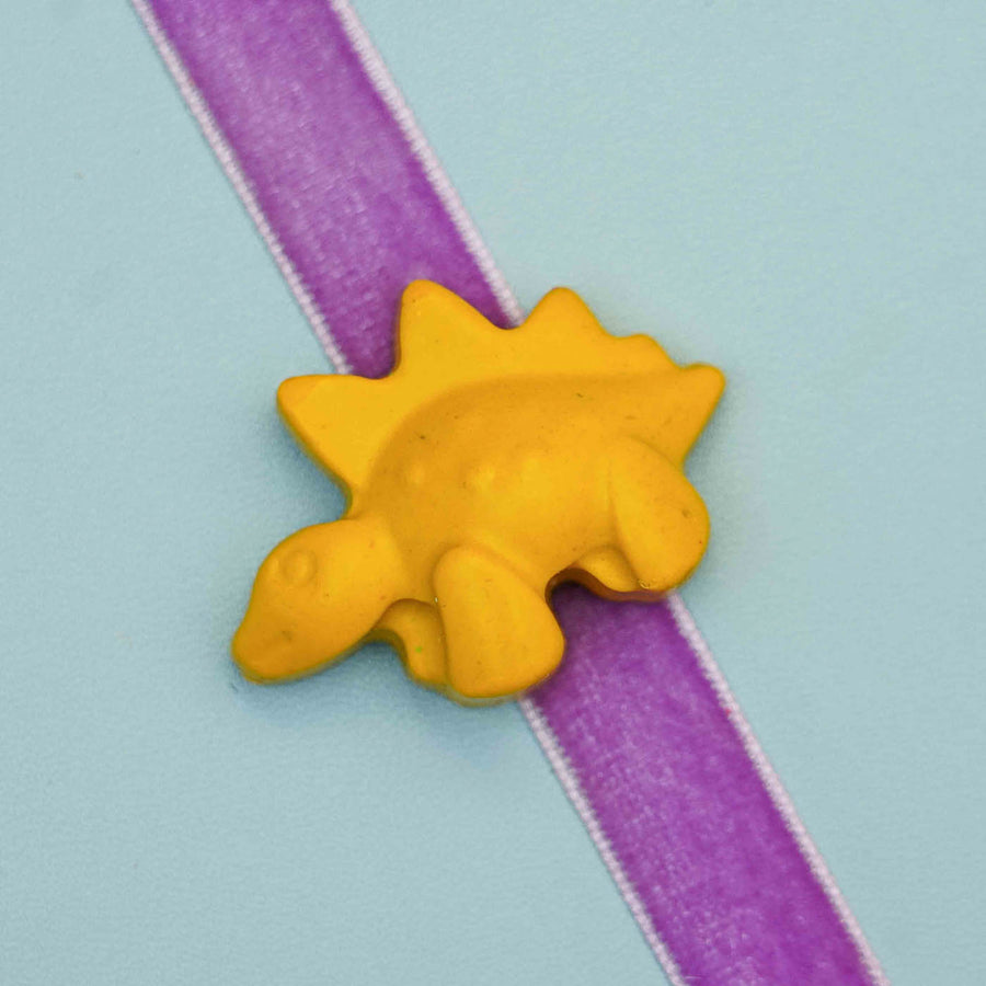 Handmade Dino Crayon Kids Rakhi With Roli Chawal - Close-up of yellow dinosaur charm