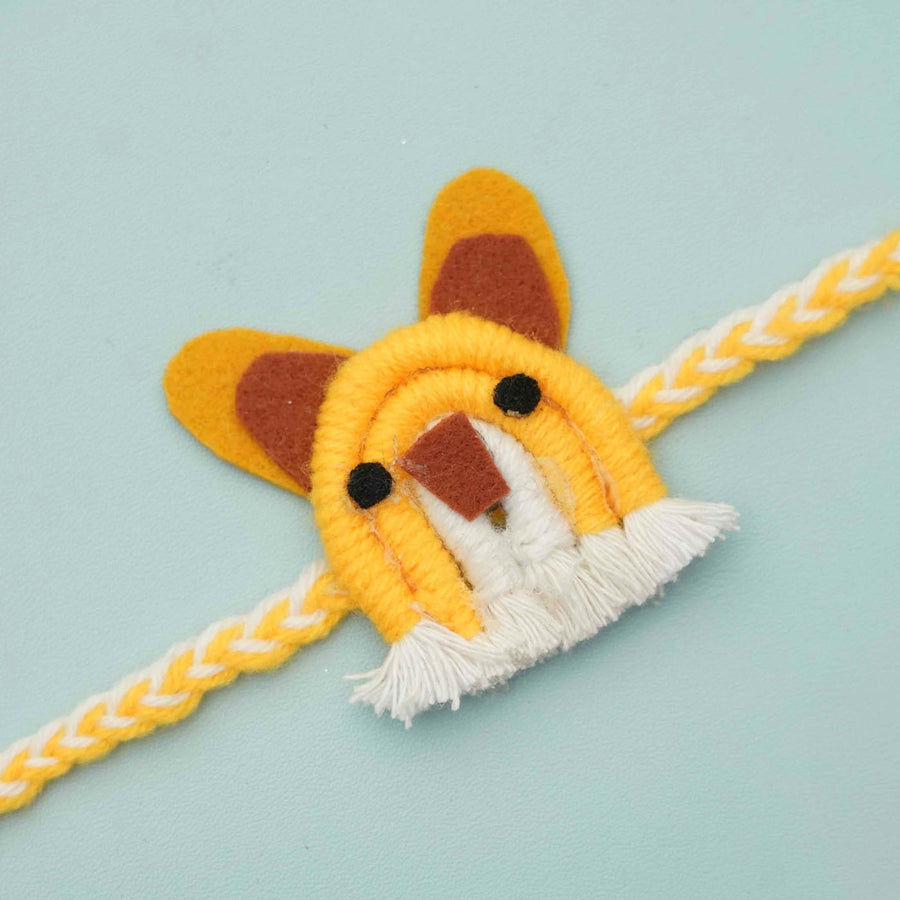 Handmade Macrame Yellow Mouse Design Cotton Kids Rakhi With Chocolates And Roli Chawal - Close-up of single rakhi thread