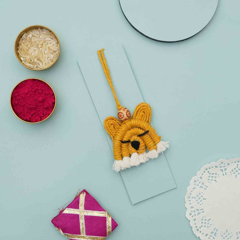 Handmade Macrame Tiger Design Cotton Kids Rakhi For Girls With Chocolates And Roli Chawal - Flat lay with decorative items