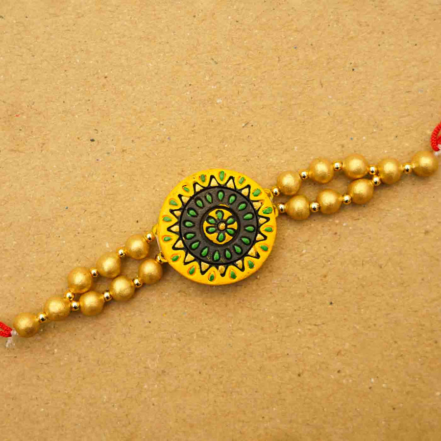Handmade Ecofriendly Round Terracotta Rakhi With Roli Chawal - Close-up View on Surface