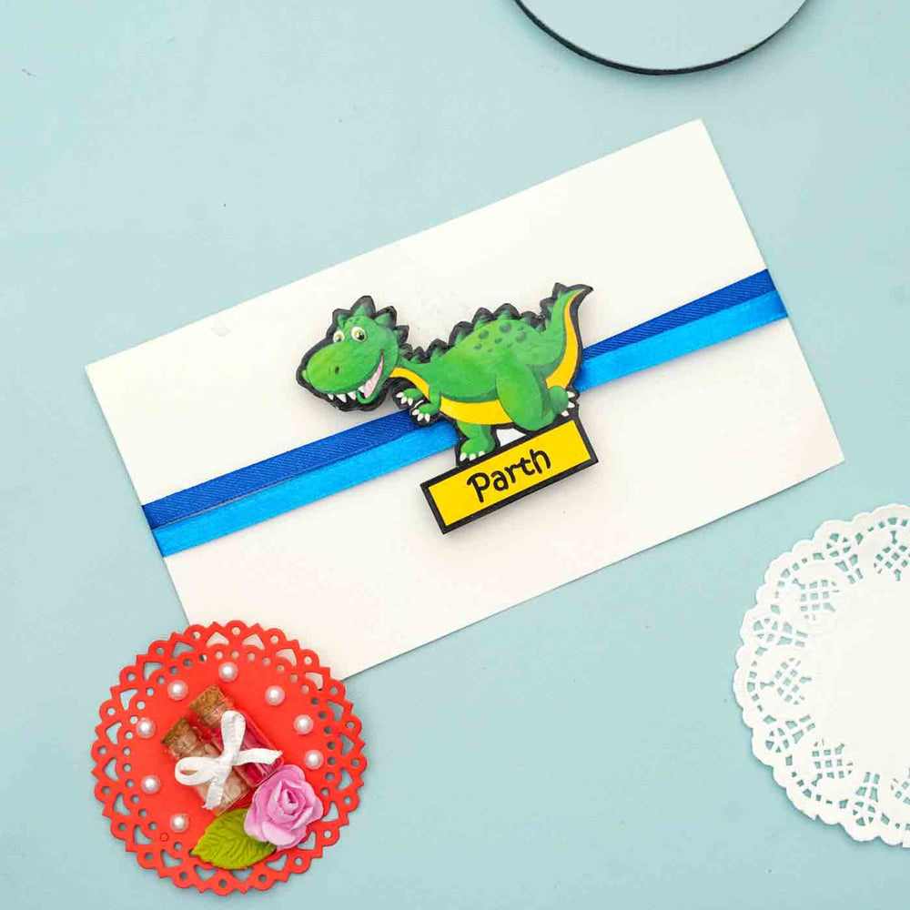 Personalized Reusable X Large Dinosour Mdf Wood Rakhi With Chocolates And Roli Chawal - Gift Card with Attached Dinosaur