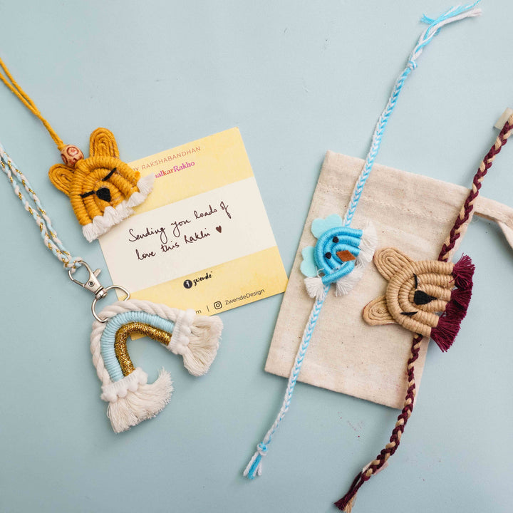 Handmade Macrame White Bunny Design Cotton Kids Rakhi For Girls With Chocolates And Roli Chawal - Flat Lay with Note and Bag