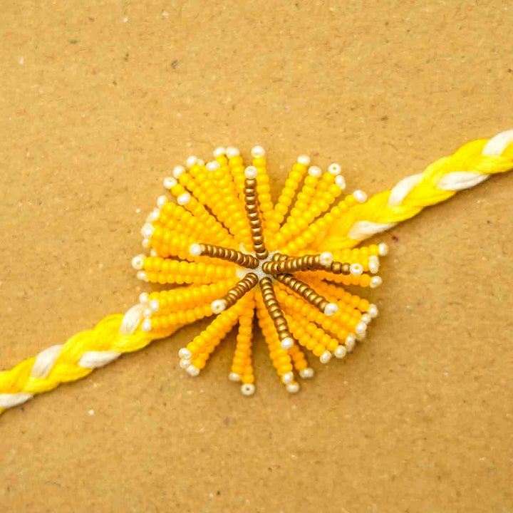 Reusable Beaded Yellow Flower Rakhi With Roli Chawal - Close-up of Center Beads