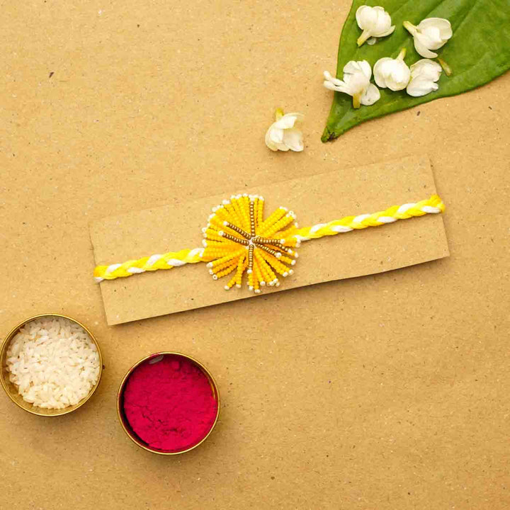 Reusable Beaded Yellow Flower Rakhi With Roli Chawal - Packaged on Cardboard Backing