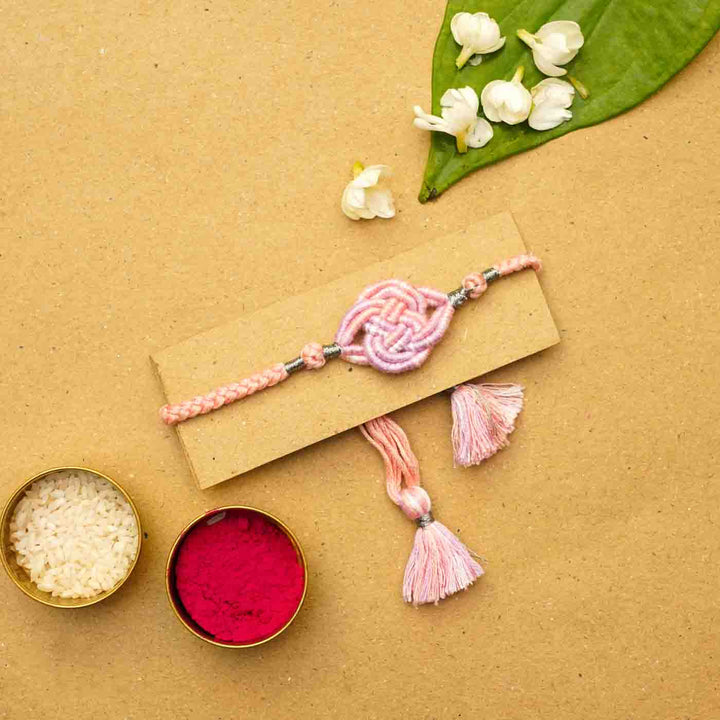 Reusable Embroidered Pink Ombre Infinity Knot Rakhi With Roli Chawal - Styled Product with Decorative Elements