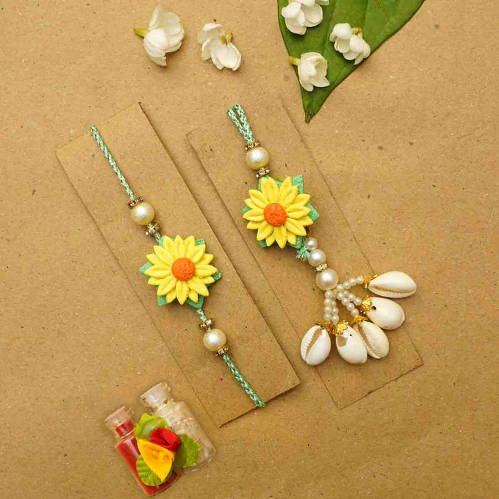 Handmade Yellow Flower Clay Bhaiya Bhabhi Rakhi With Chocolates And Roli Chawal Set Of 2 - Rakhis on display cards