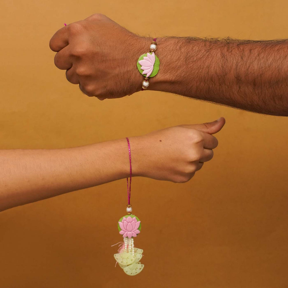 Handmade Lotus Clay Bhaiya Bhabhi Rakhi With Chocolates And Roli Chawal Set Of 2 - Rakhis worn on wrists