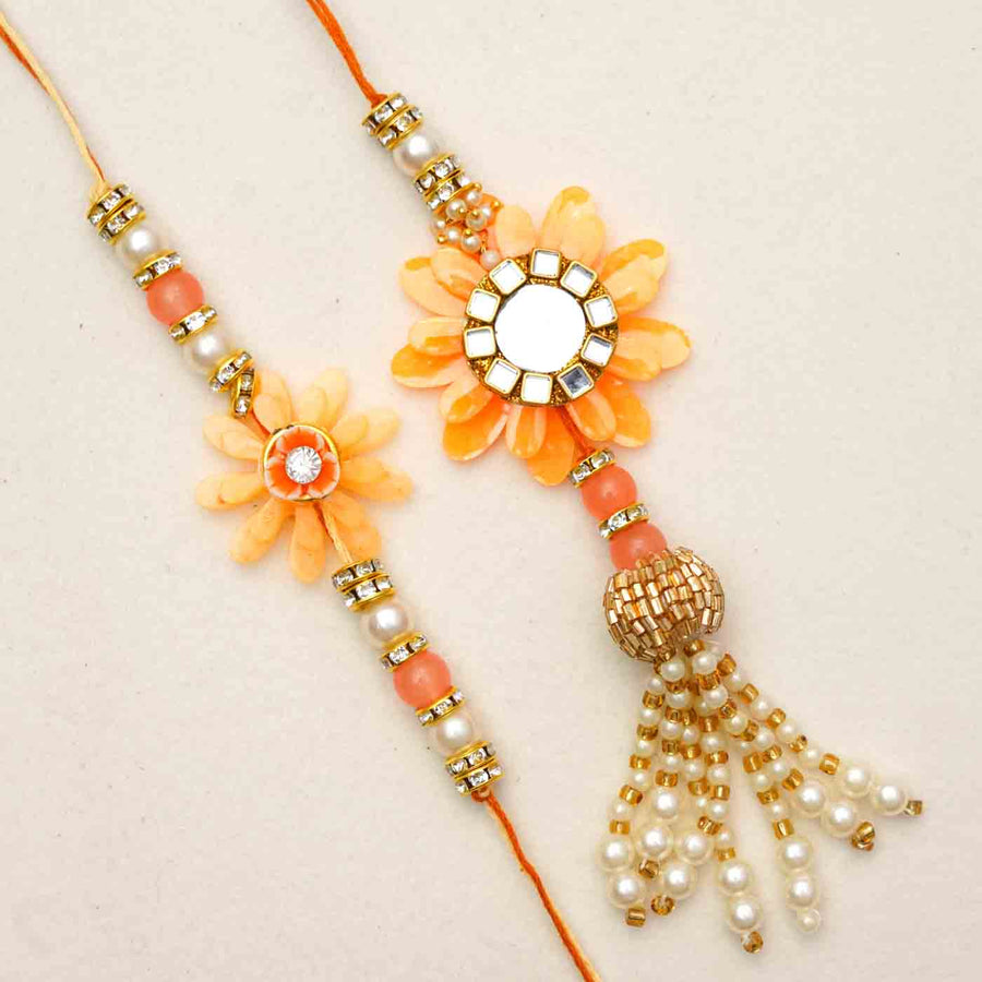 Handmade Resin Peach Flower With Kundan Bhaiya Bhabhi Rakhi With Chocolates And Roli Chawal Set Of 2 - Close-up of two rakhis