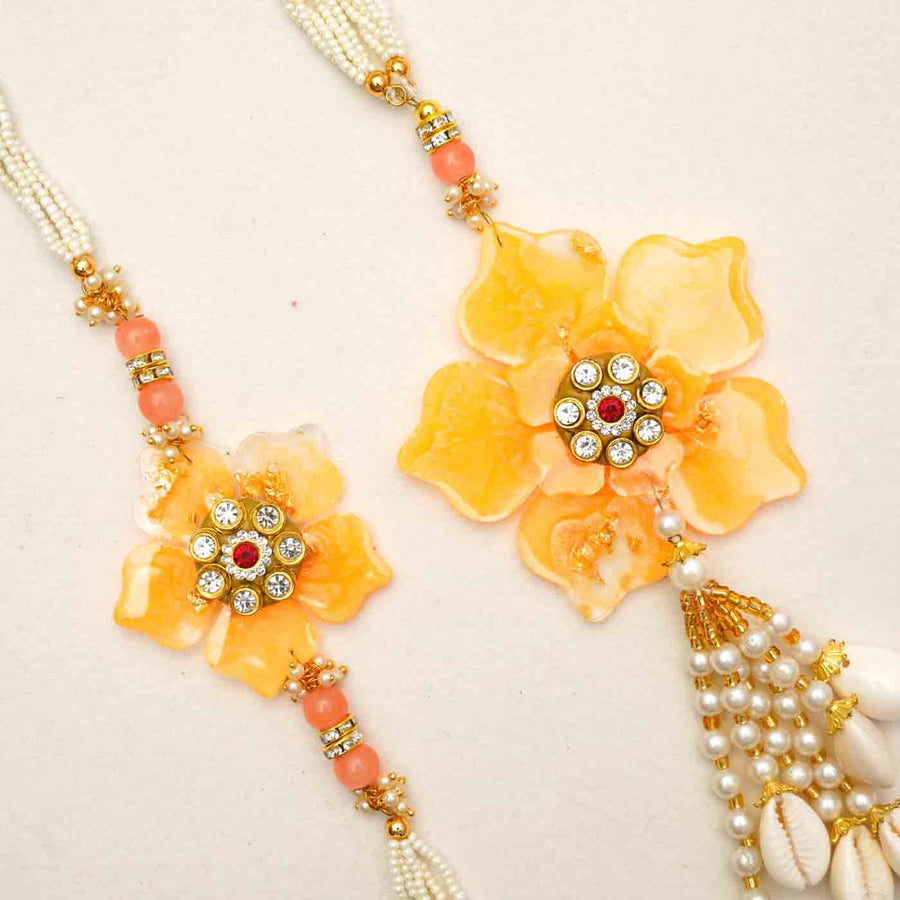 Handmade Yellow Flower Theme Resin Bhaiya Bhabhi Rakhi With Chocolates And Roli Chawal For Bhaiya And Bhabhi Set Of 2 - Close-up of Floral Rakhi Pair