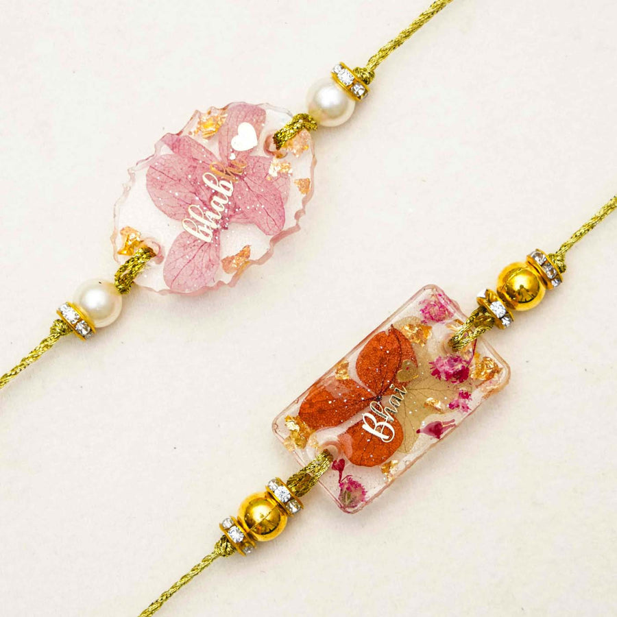 Handmade Resin Pink Bhaiya Bhabhi Rakhi With Roli Chawal - Close-up of two bracelets