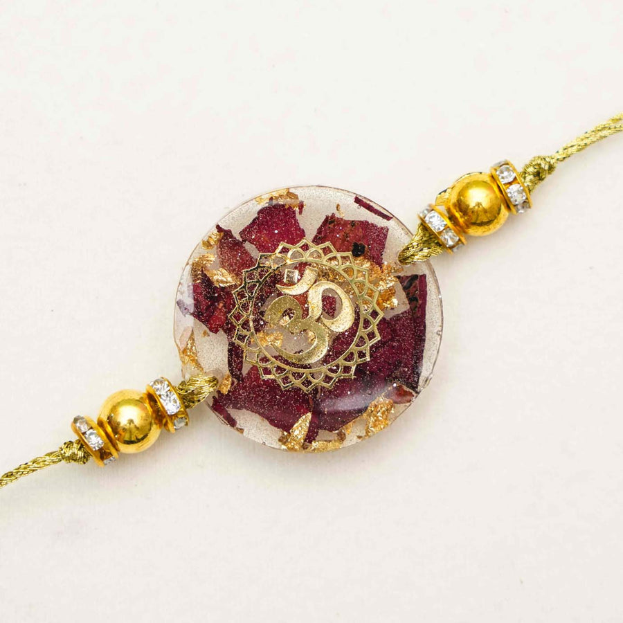 Handmade Resin Round Om Rakhi With Roli Chawal - Close-up Front View