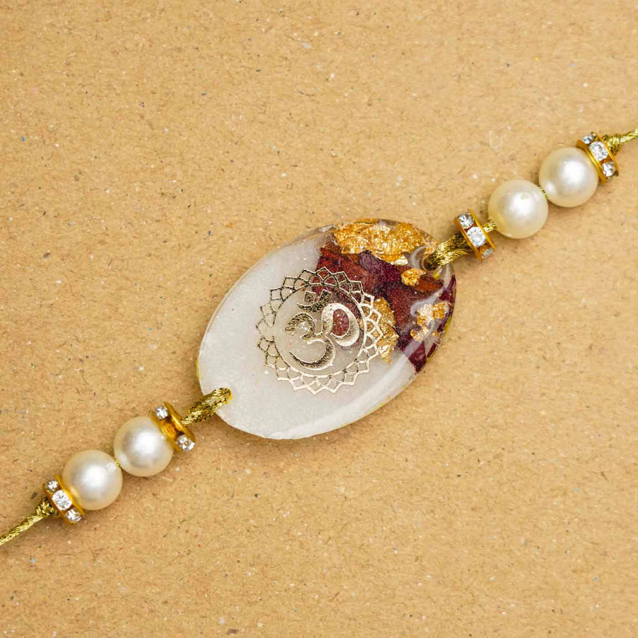 Handmade Resin Om Presserved Flower Rakhi With Roli Chawal - Close-up of Decorative Bracelet