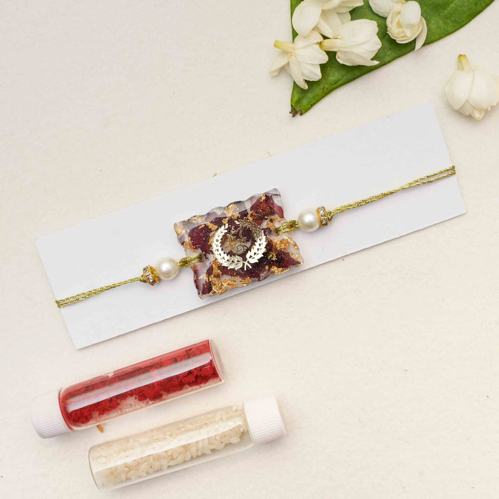 Handmade Resin Ganesha Presserved Flower Rakhi With Roli Chawal - Packaging Presentation