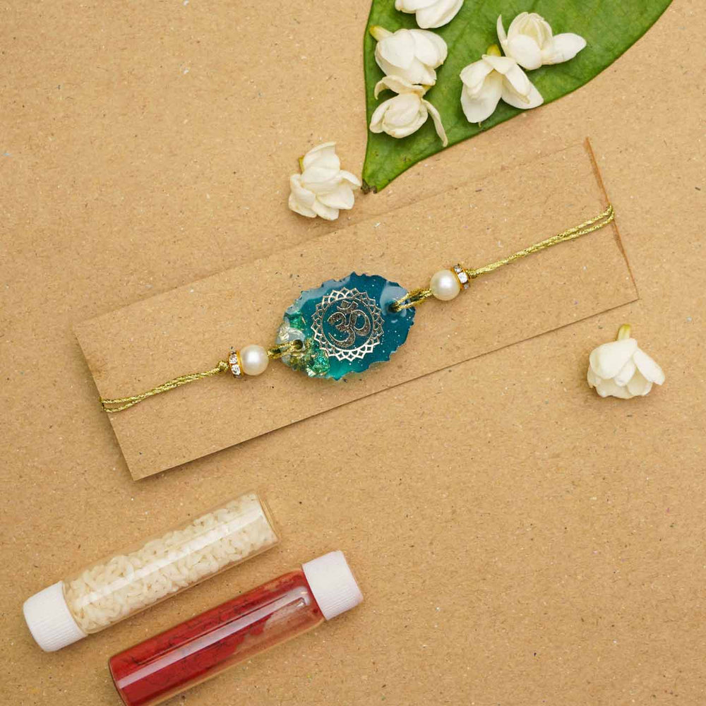 Handmade Resin Oval Om Rakhi With Roli Chawal - Bracelet on display card with decor
