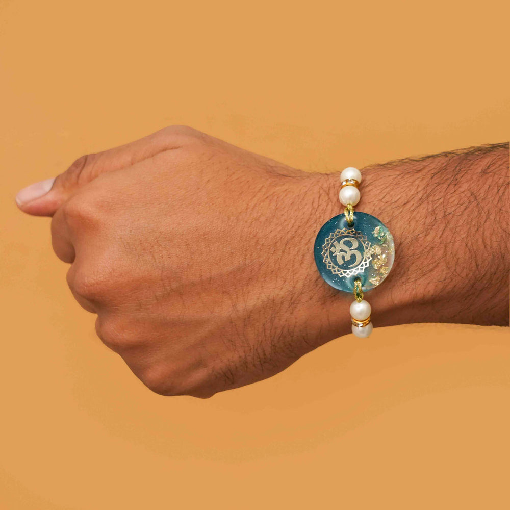 Handmade Resin Round Om Rakhi With Roli Chawal - Worn on Wrist