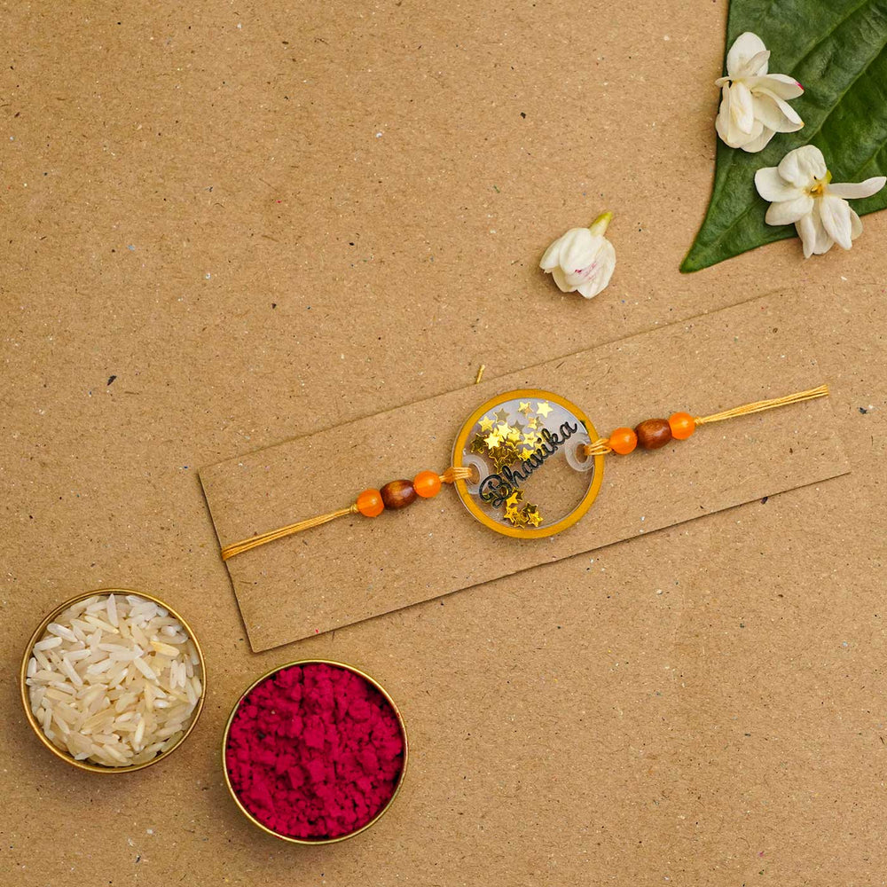 Personalized Handmade Round Glitter Acrylic Rakhi With Roli Chawal - Packaged with rice and kumkum