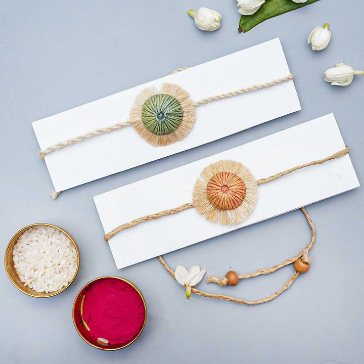 Handmade Papier Mache Rustic And Green Mushroom Rakhi With Roli Chawal Set Of 2 - Bands displayed with packaging and accessories
