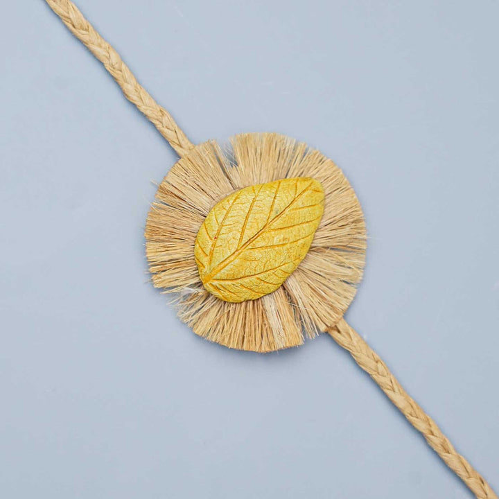 Handmade Papier Mache Yellow Leaf Rakhi With Roli Chawal - Close-up of Rakhi Detail