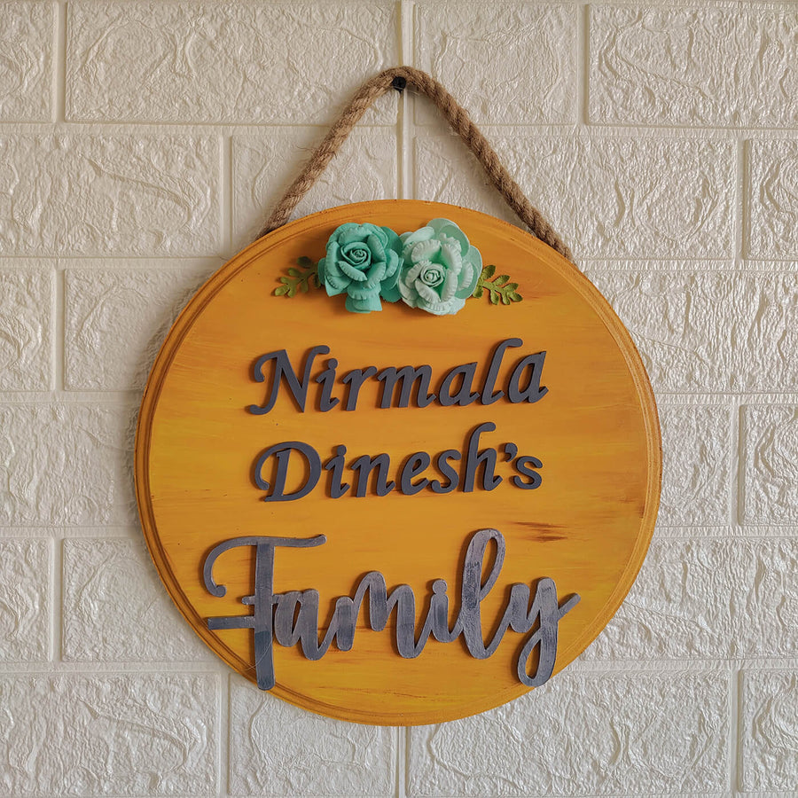 Handcrafted Personalized Wooden Floral Name Plate - Hanging on Rope Against Wall