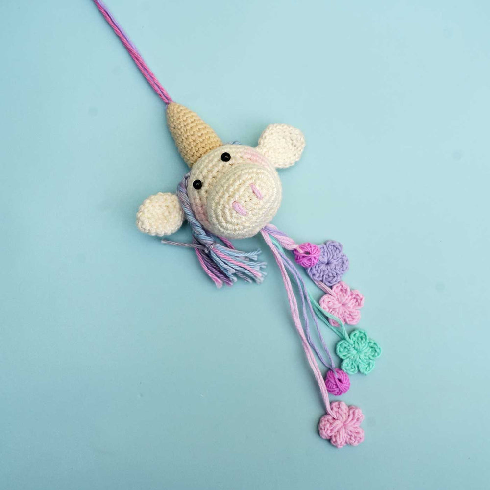 Handmade Crochet Unicorn For Girl Cotton Kids Rakhi With Roli Chawal - Front Angled View